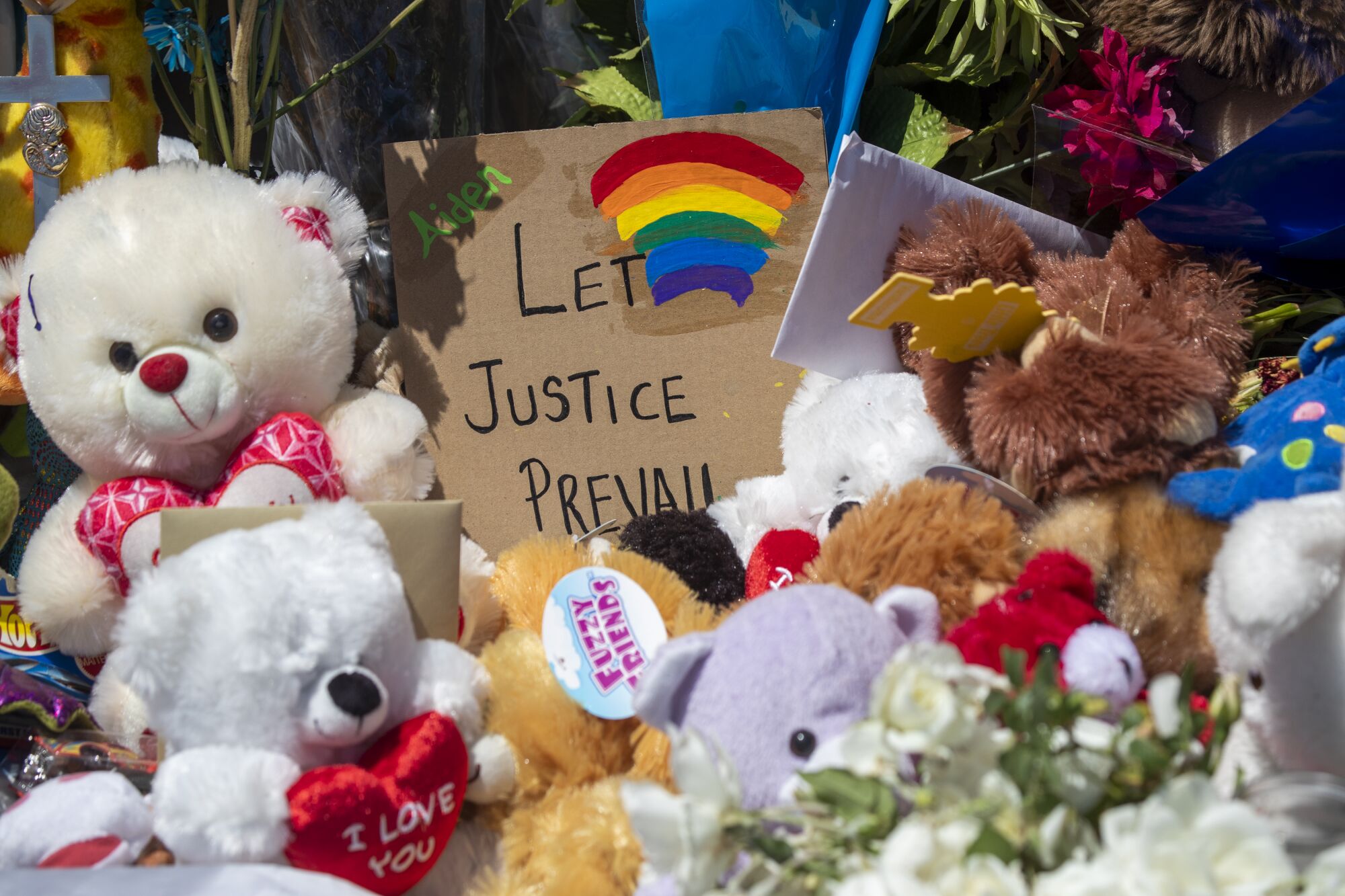Stuffed animals and other items create a memorial for Aiden Leos on the Walnut Avenue overpass of the 55 Freeway in Orange.