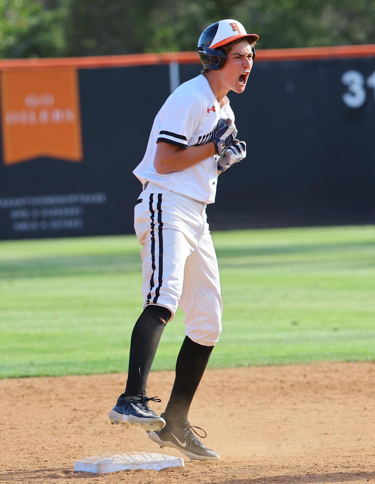 Jared Grindlinger of Huntington Beach lets out a yell after delivering a run-scoring hit.