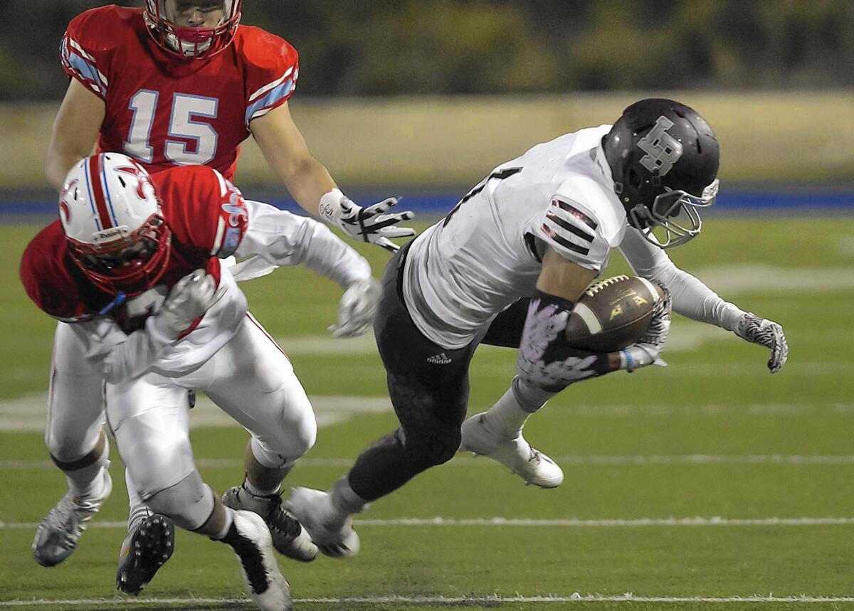 Laguna Beach High’s Adam Armstrong, right, was named the Orange Coast League Offensive MVP.