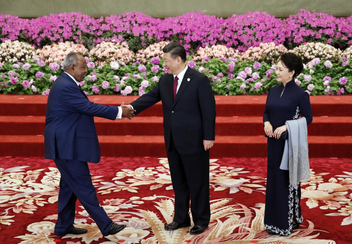 Chinese President Xi Jinping, center, and his wife Peng Liyuan welcome Djibouti's president, Ismail Omar Guelleh, at the Belt and Road Forum in Beijing in April 2019.