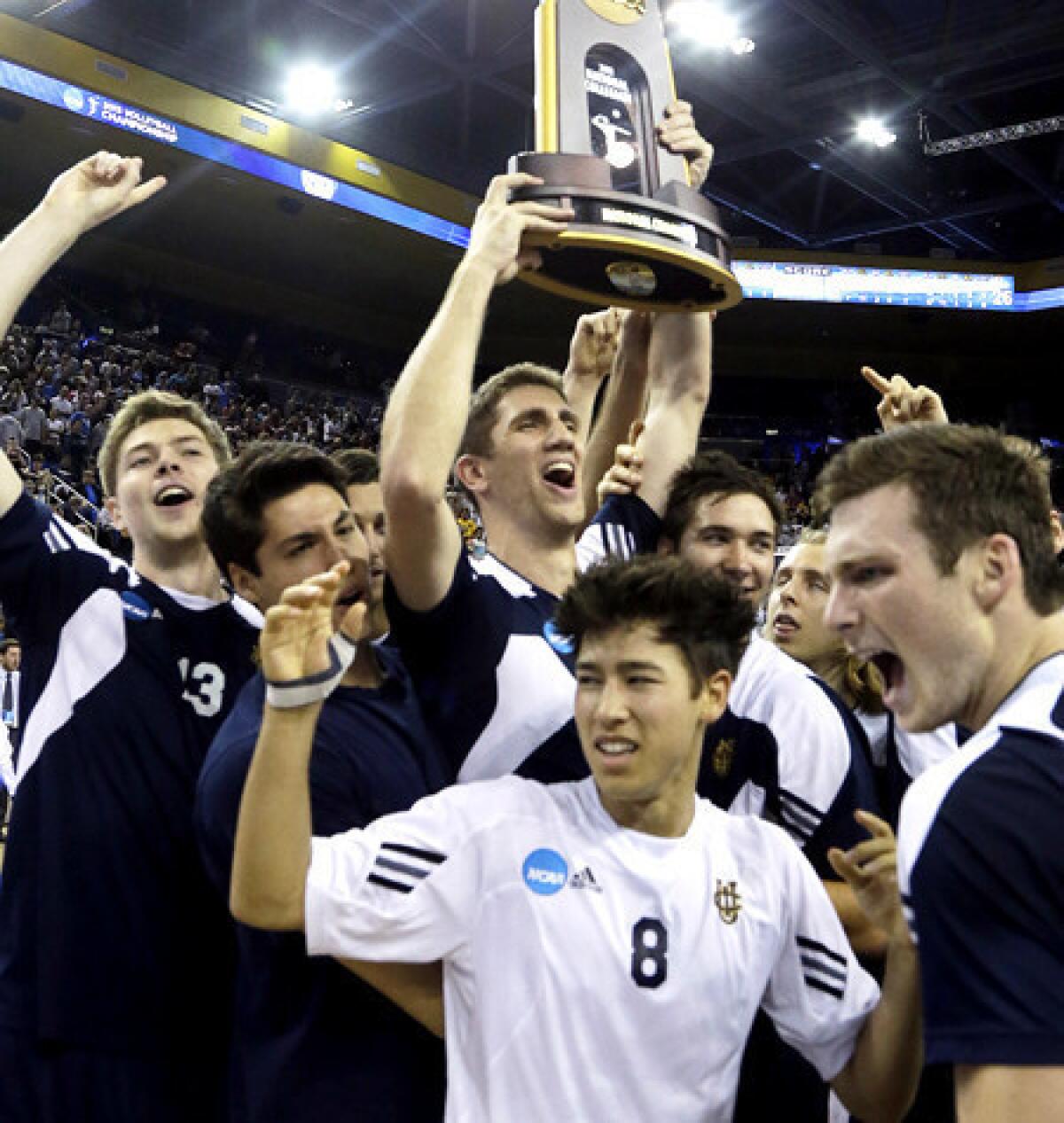 UC Irvine players hold the championship trophy as they celebrate their victory over Brigham Young in the NCAA men's volleyball tournament final on Saturday at Pauley Pavilion.