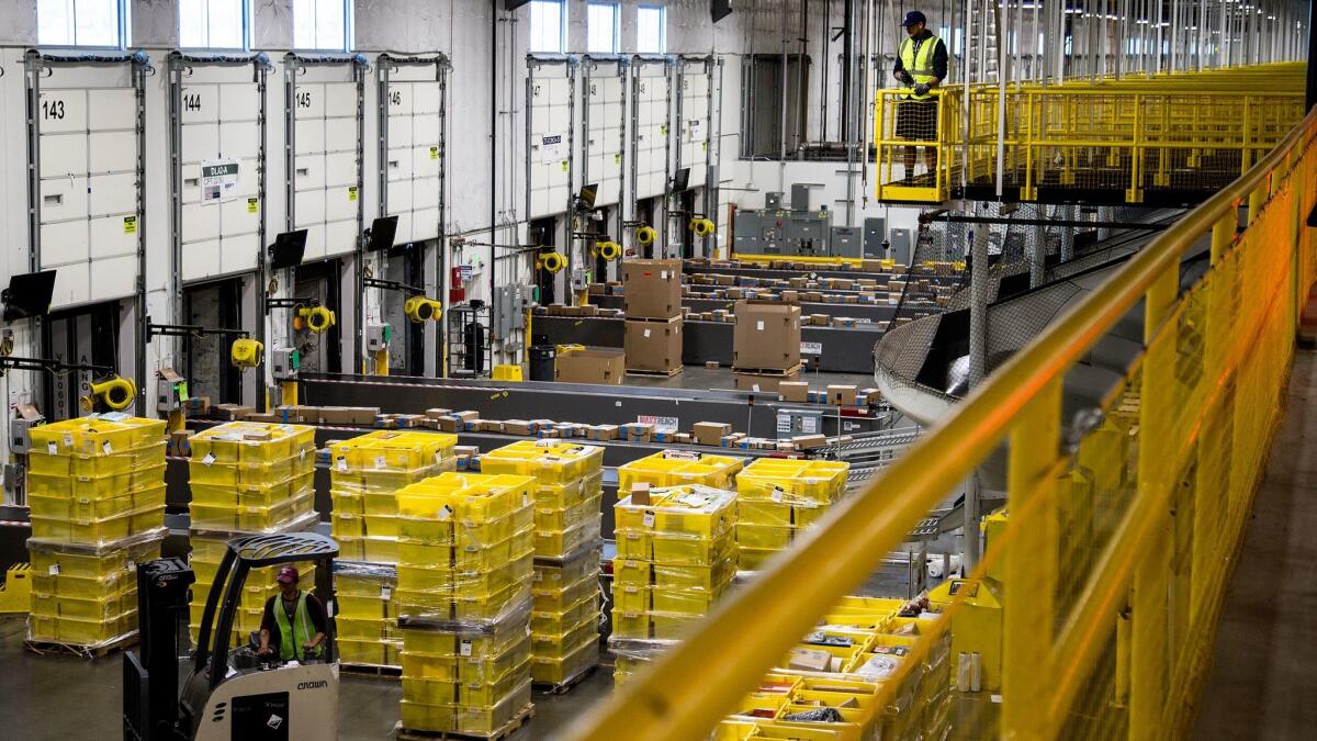 Packages move along a conveyor belt at the Amazon Fulfillment Center in San Bernardino (Gina Ferazzi / Los Angeles Times)
