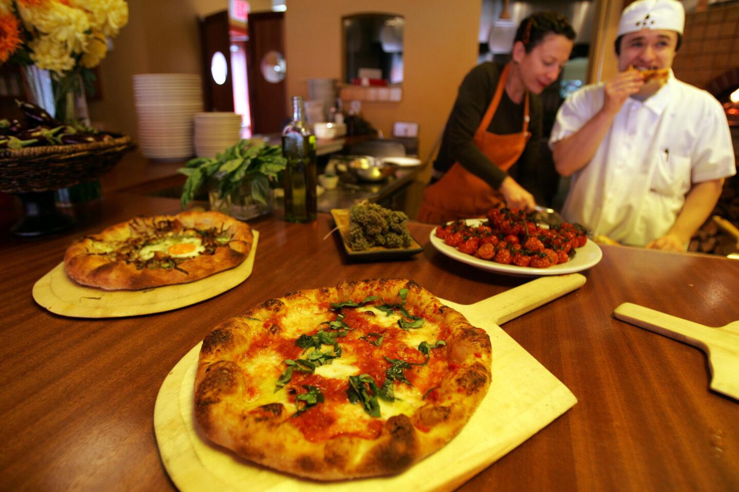 Chef-owner Nancy Silverton (left) and executive chef Matt Molina making pizzas at Mozza.