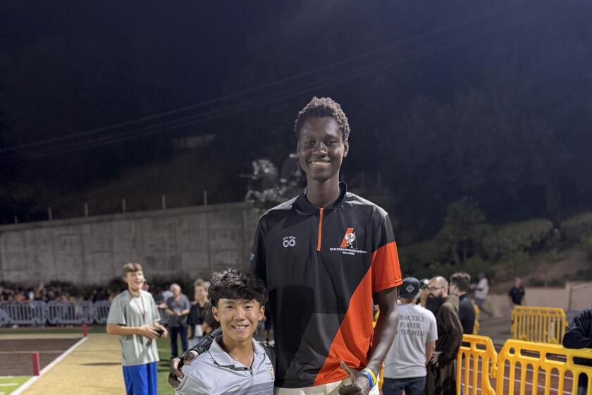 St. Francis standout sophomore golfer Jaden Soong hangs out with 7-4 classmate Cherif Millogo.