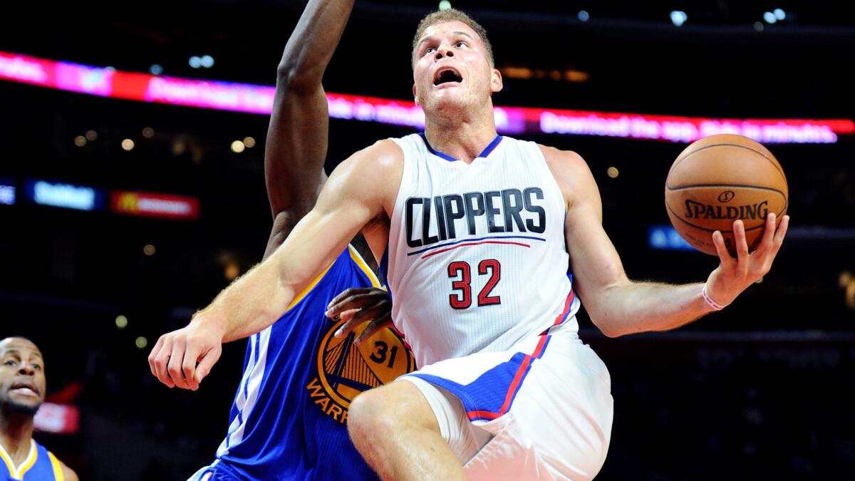 Clippers forward Blake Griffin drives down the lane against Warriors center Festus Ezeli during a Nov. 19 game at Staples Center.