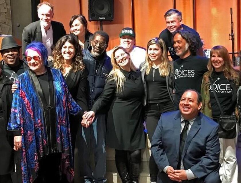 Filmmaker Susan Polis Schutz poses with members of Voices of Our City choir at the premiere of her documentary, ‘The Homeless Chorus Speaks.’