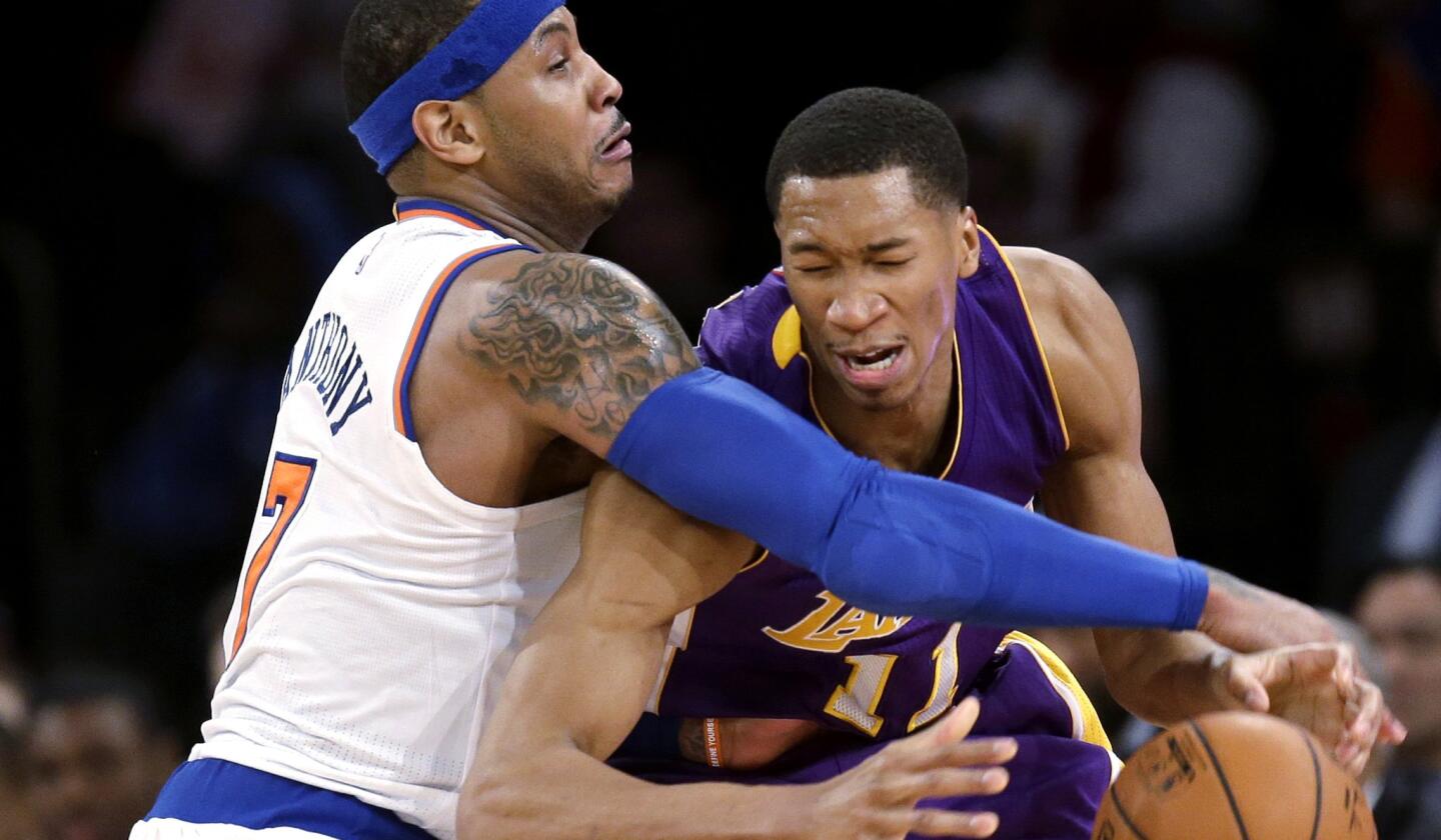 Knicks forward Carmelo Anthony fouls Lakers forward Wesley Johnson while trying to steal the ball in the second half.