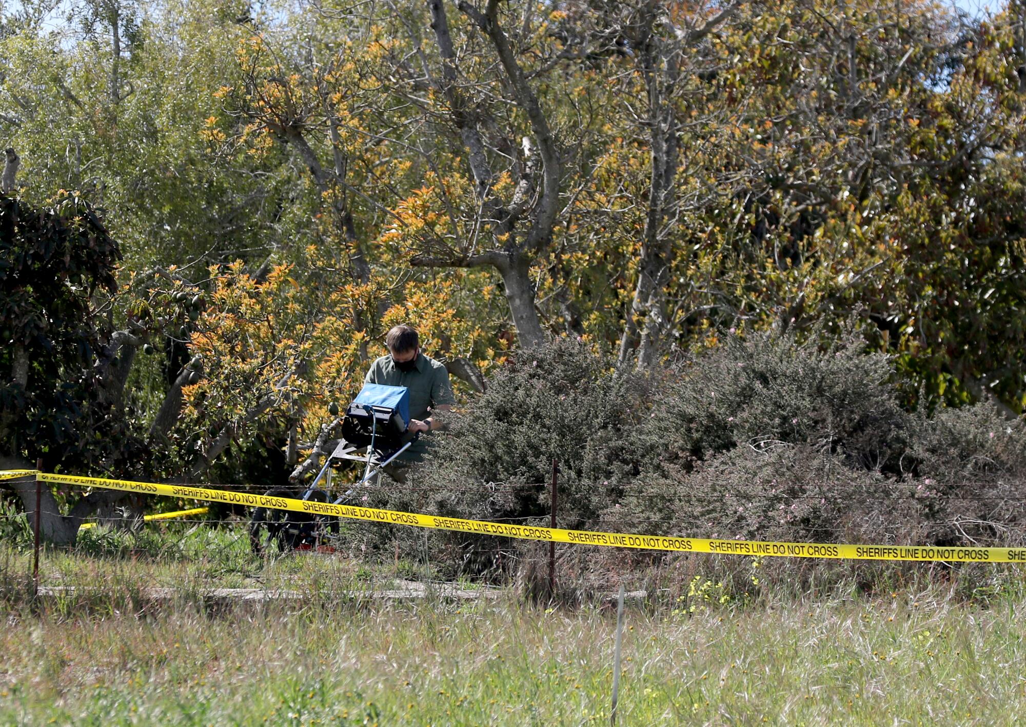 A deputy searches property. 