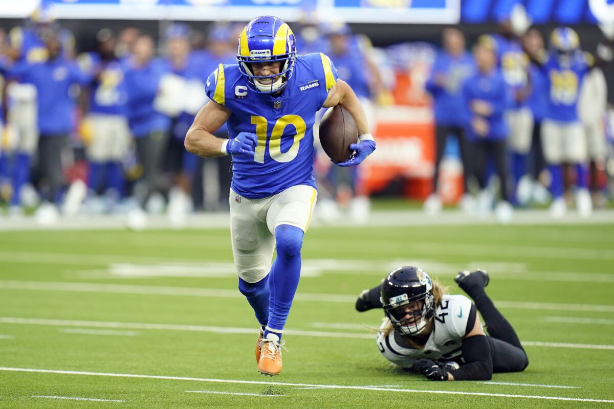 Los Angeles Rams wide receiver Cooper Kupp (10) runs for a touchdown past Jacksonville Jaguars safety Andrew Wingard during the second half of an NFL football game Sunday, Dec. 5, 2021, in Inglewood, Calif. (AP Photo/Jae C. Hong)