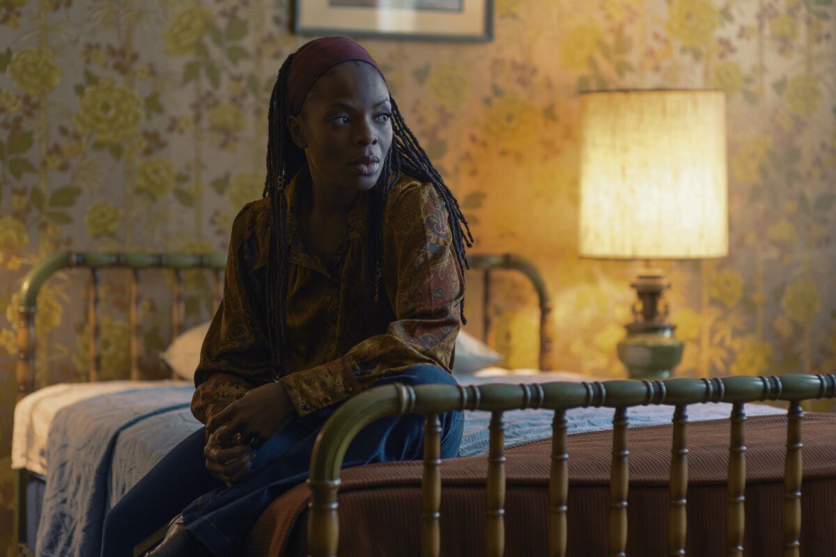 Marsha Stephanie Blake sits on a bed in the movie "I'm Your Woman."