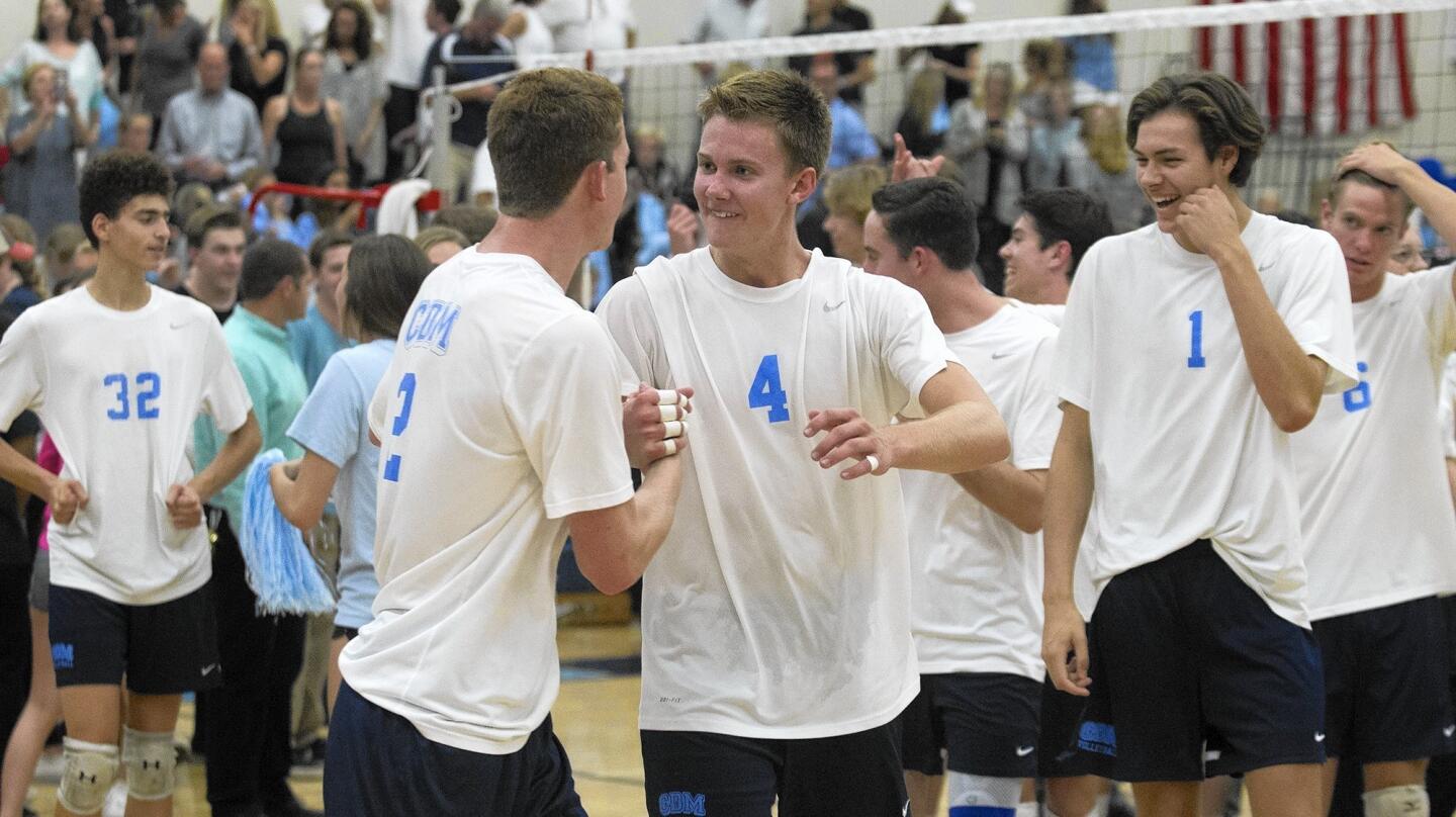 Corona del Mar High's Matt Ctvrtlik (4), who amassed 51 assists, to go with five digs, two kills, two block assists and two service aces, celebrates with teammate Mitch Haly after the Sea Kings defeat Beckman in four sets in the CIF Southern California Division 1 Regional semifinal match on Thursday.