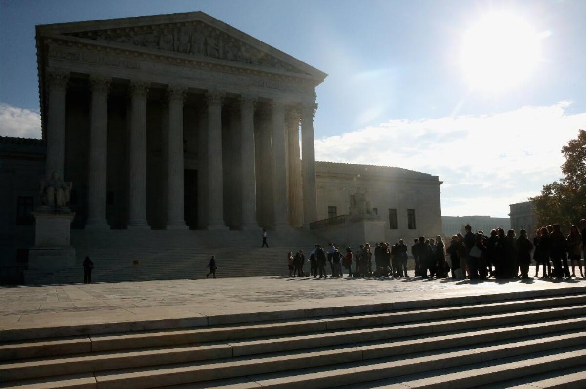 People stand in line outside the U.S. Supreme Court building in November.