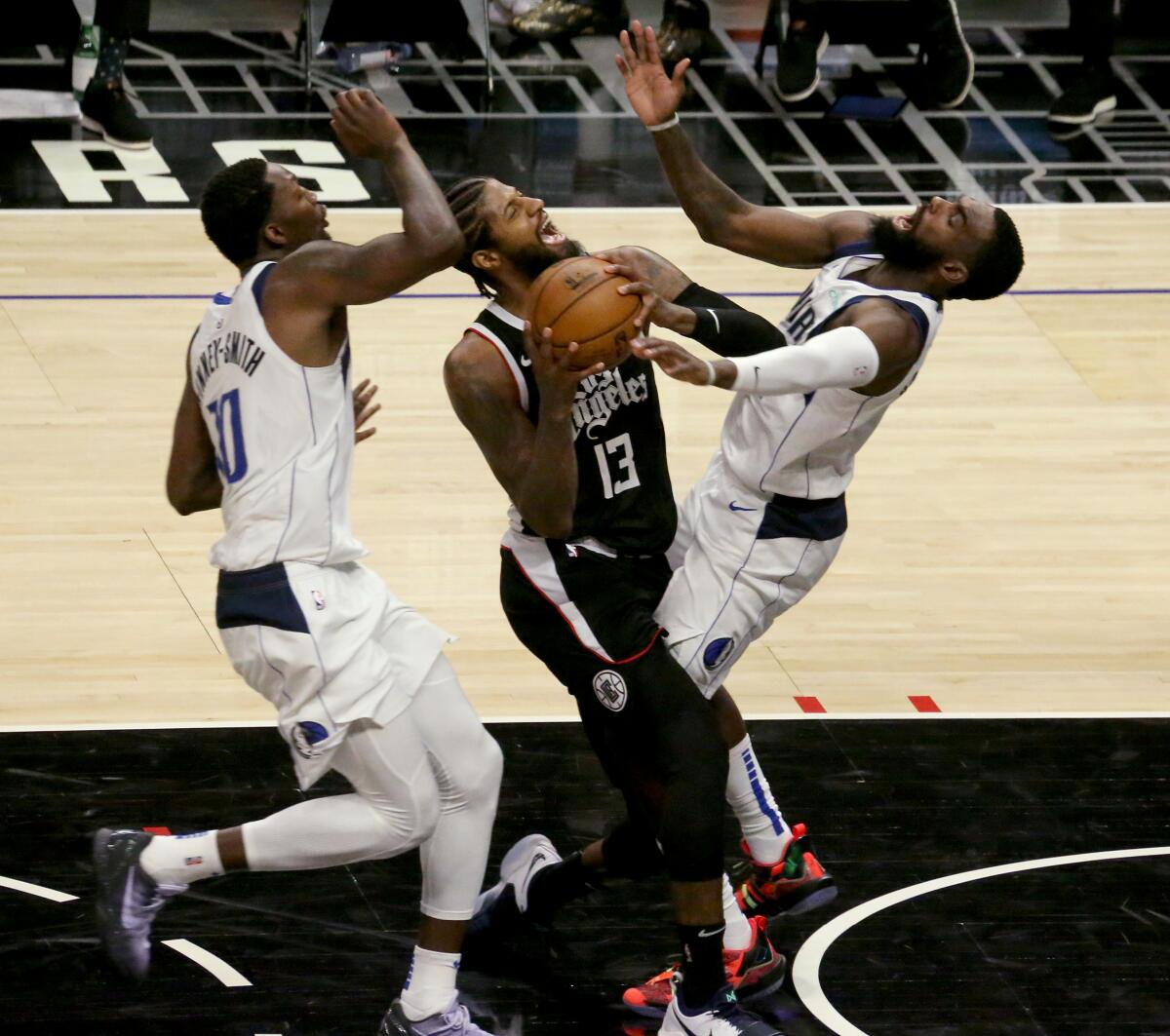 Clippers star Paul George charges into Mavericks guard Tim Hardaway Jr.