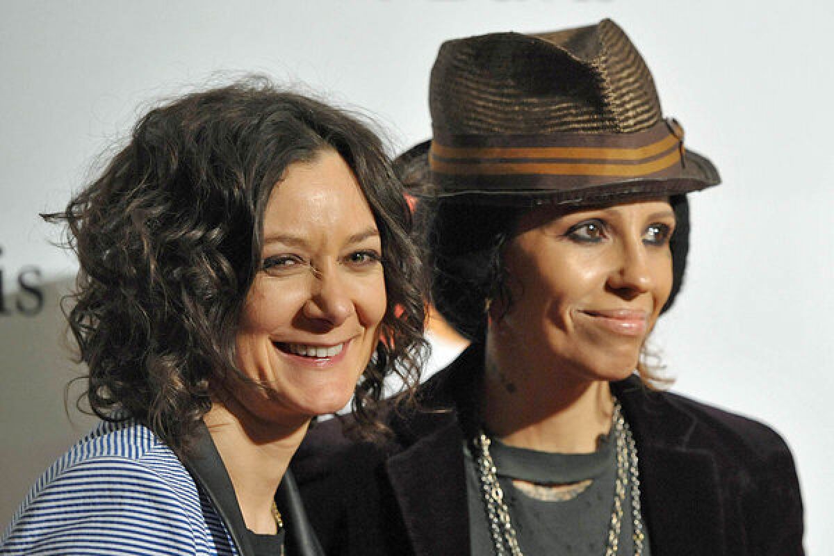 Sara Gilbert, with girlfriend Linda Perry at Clive Davis' pre-Grammy party in February, announced their engagement Monday on "The Talk."