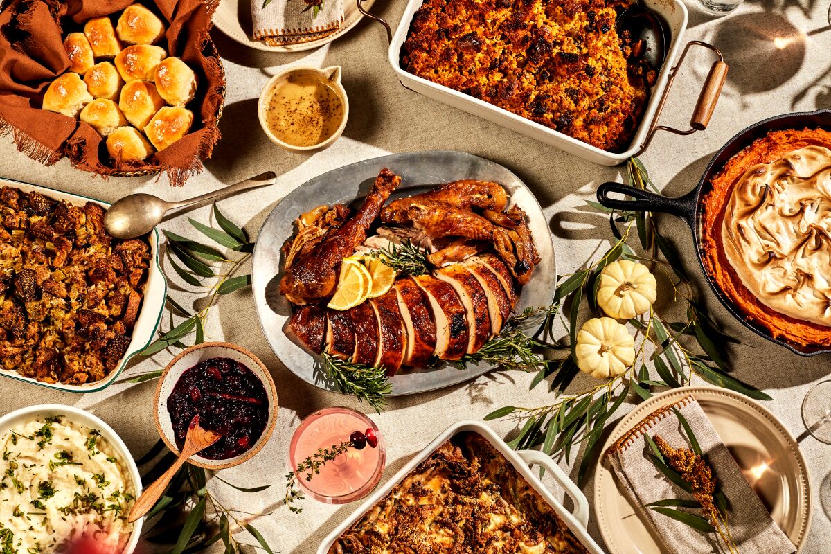 A Thanksgiving spread includes turkey and carved sides.