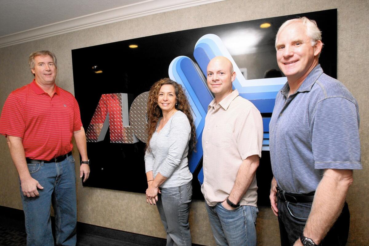 David Lund, ALC VP Sales & Operations, left, Tracey Lewin, ALC L.A. Sales Office Manager, second from left, Steve Doerfler, ALC CFO, second from right, and Kenny Lund, Allen Lund Company VP Support Operations, right, in their building on Angeles Crest Highway in La Cañada Flintridge on Friday, Jan. 29, 2016. The company, headquartered in La Cañada, has been in business 40 years.