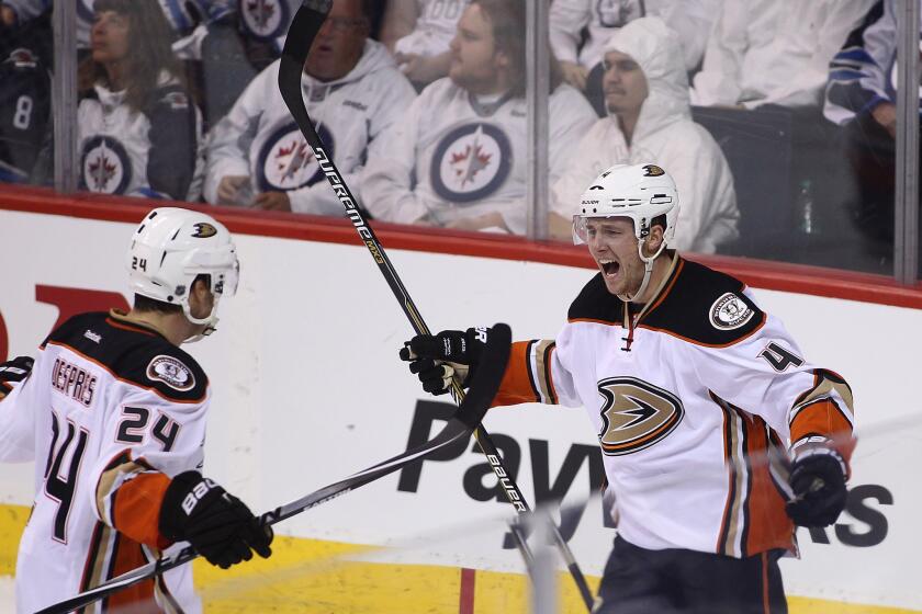 Ducks defenseman Cam Fowler (4) celebrates with teammate Simon Despres after scoring in the first period of Game 3.