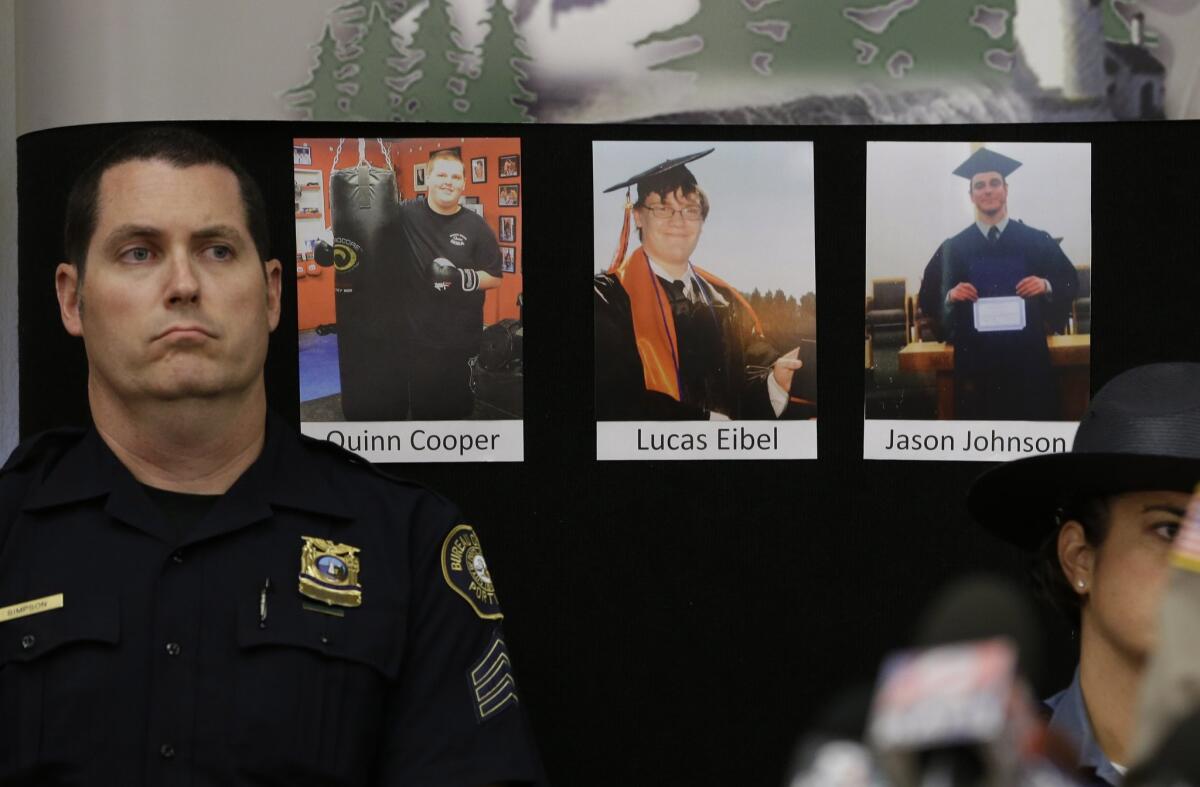 Photos of three of the victims of the mass shooting at Umpqua Community College are displayed at a news conference on Friday, Oct. 2, in Roseburg, Ore.