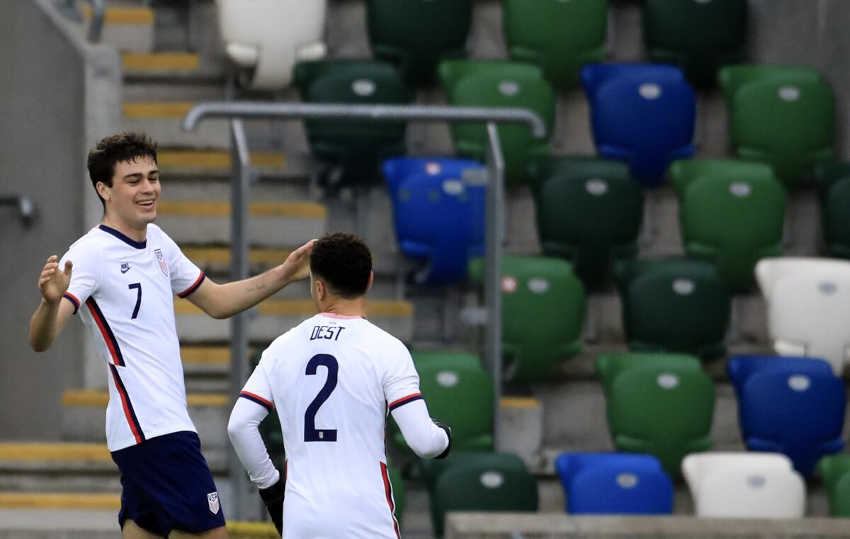 United States's Gio Reyna, left, celebrates with Sergino Dest after scoring 
