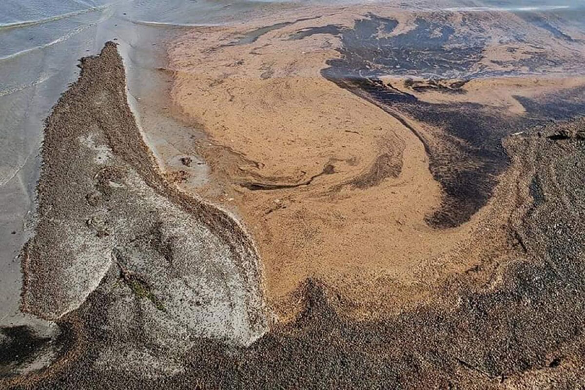 An aerial view shows a swirl of light brown on Great Salt Lake.