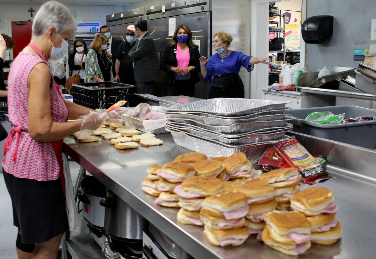 People work in nonprofit's kitchen preparing sandwiches