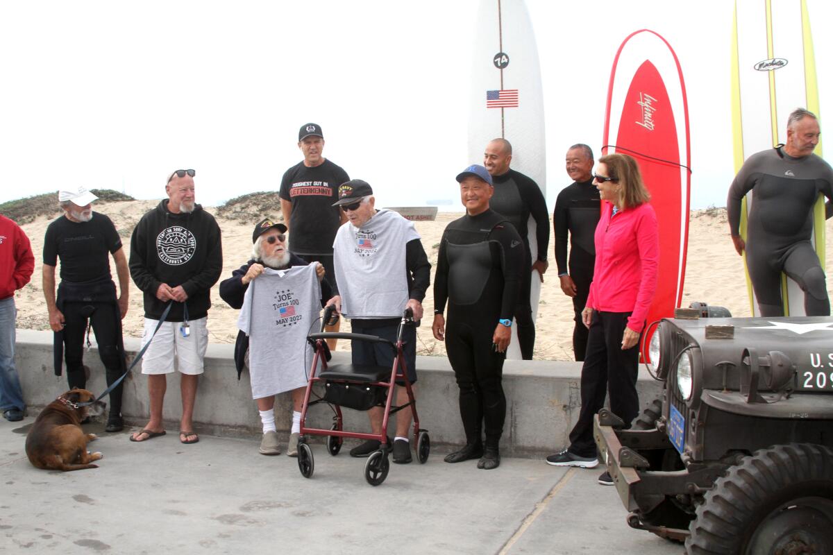 Joe Bush, who will turn 100 in May, is surrounded by friends and well-wishers on Wednesday at Bolsa Chica State Beach.