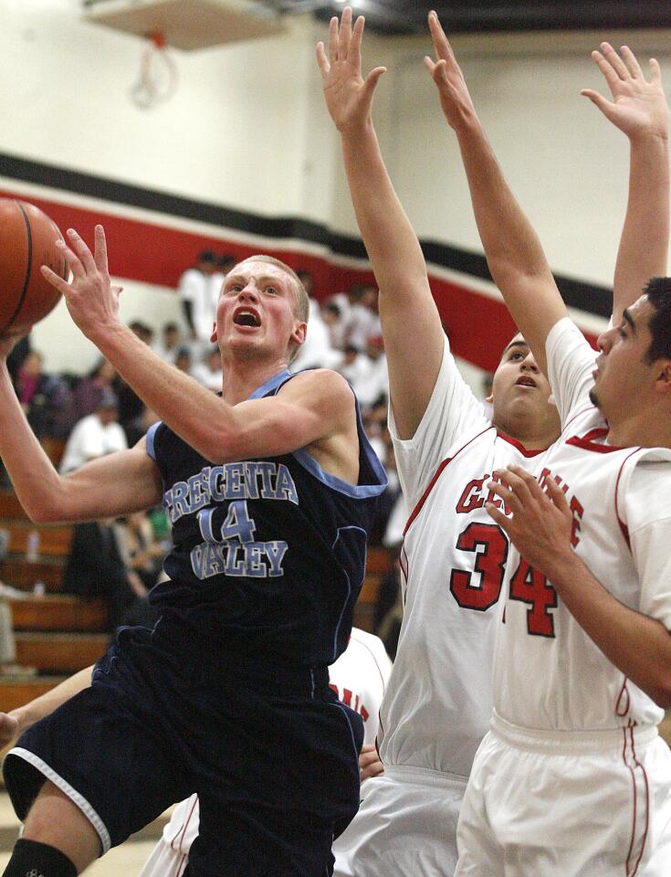 Crescenta Valley's Cole Currie takes a shot against against Glendale's Arthur Terzyan and Daryoush Rahimi at Glendale High School in a Pacific League boys basketball game at on Monday, January 7, 2013.