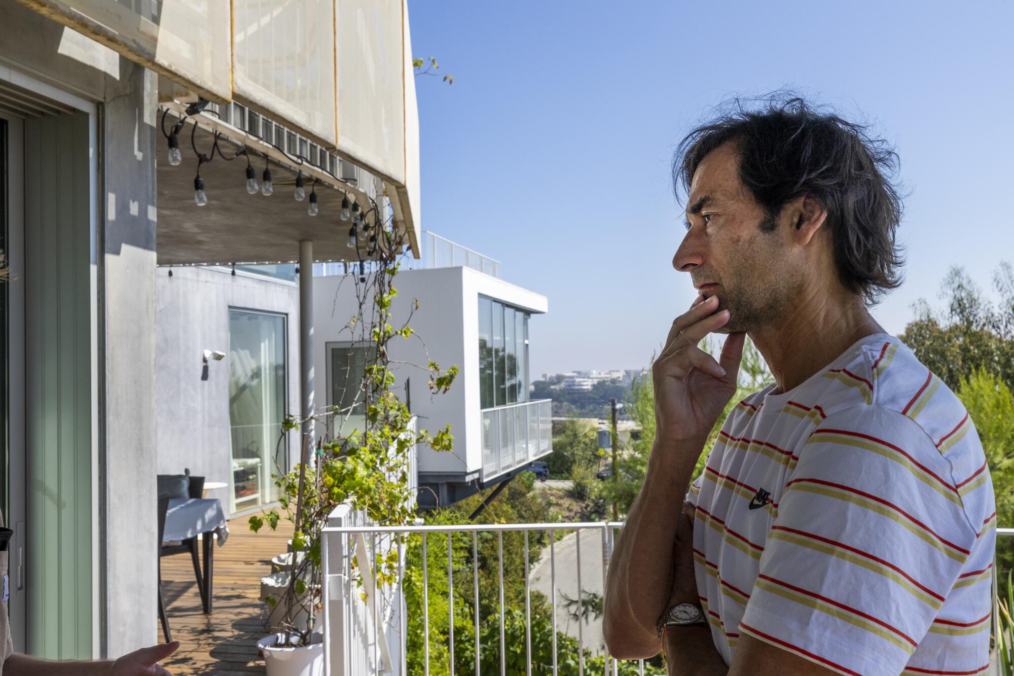 Sascha Jovanovic stands on the deck of his Los Angeles home.