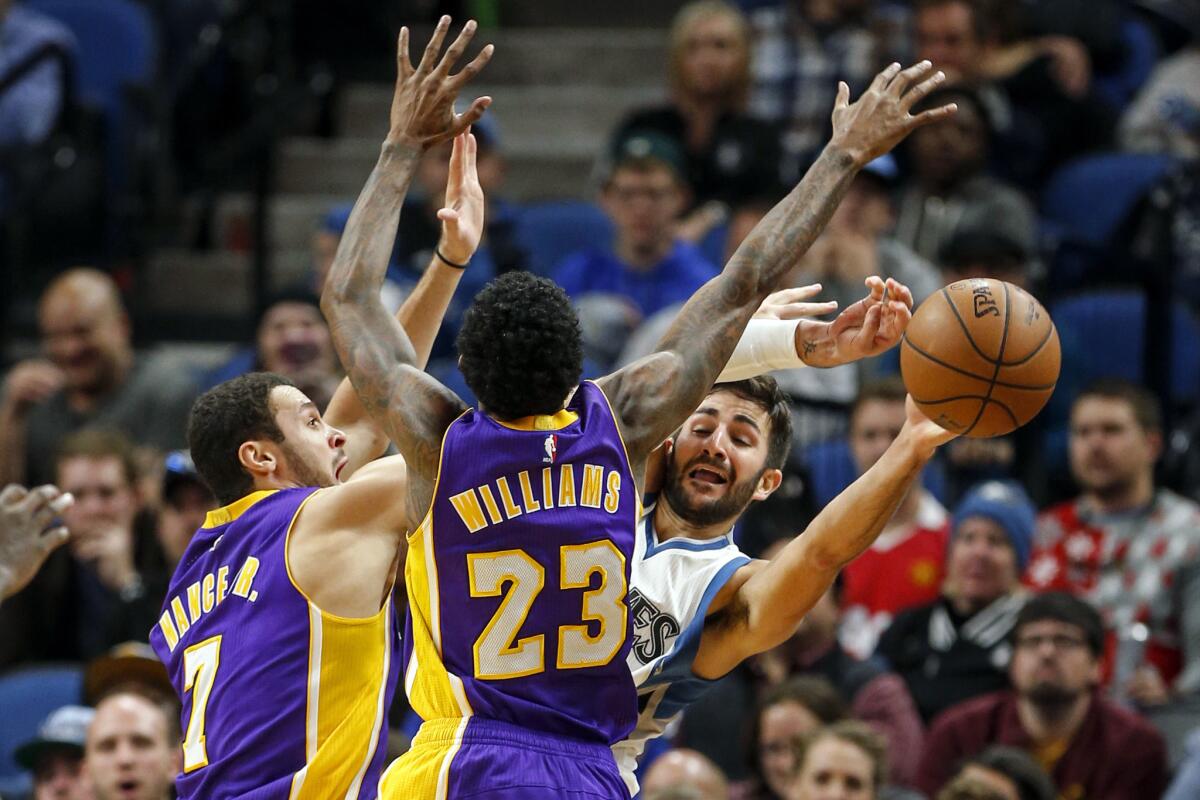 Timberwolves guard Ricky Rubio feels defensive pressure from the Lakers' Larry Nance Jr., left, and Louis Williams as he tries to pass the ball in the second half of Sunday's game.