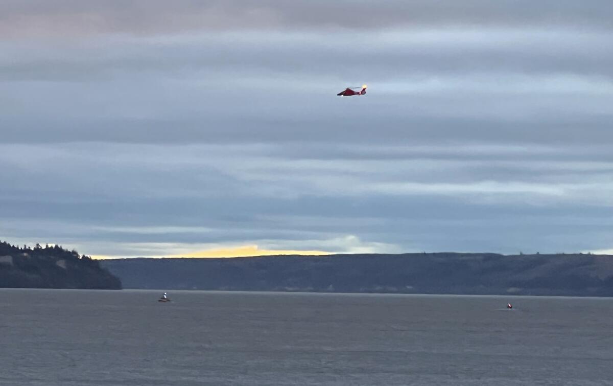 Coast Guard helicopter searching an area off Puget Sound, Wash.