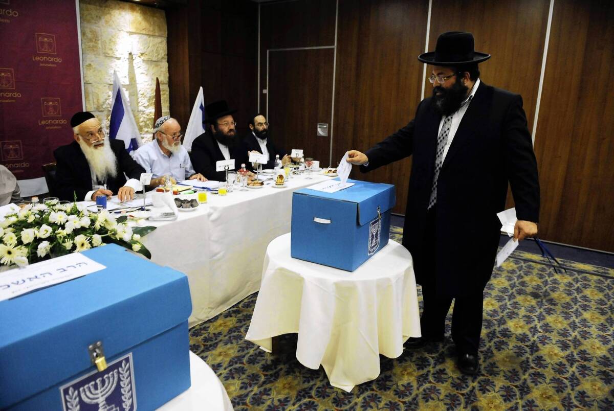 An ultra-Orthodox Jew casts his ballot during the election for Israel's two chief rabbis Wednesday in Jerusalem. Israel's two chief rabbis, for Ashkenazi and Sephardi, have responsibilities that include the country's rabbinical courts and regulating the food supervision industry.