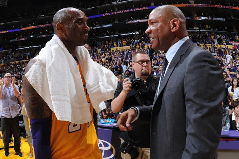 Lakers legend Kobe Bryant and Clippers coach Doc Rivers chat after a game in 2016.