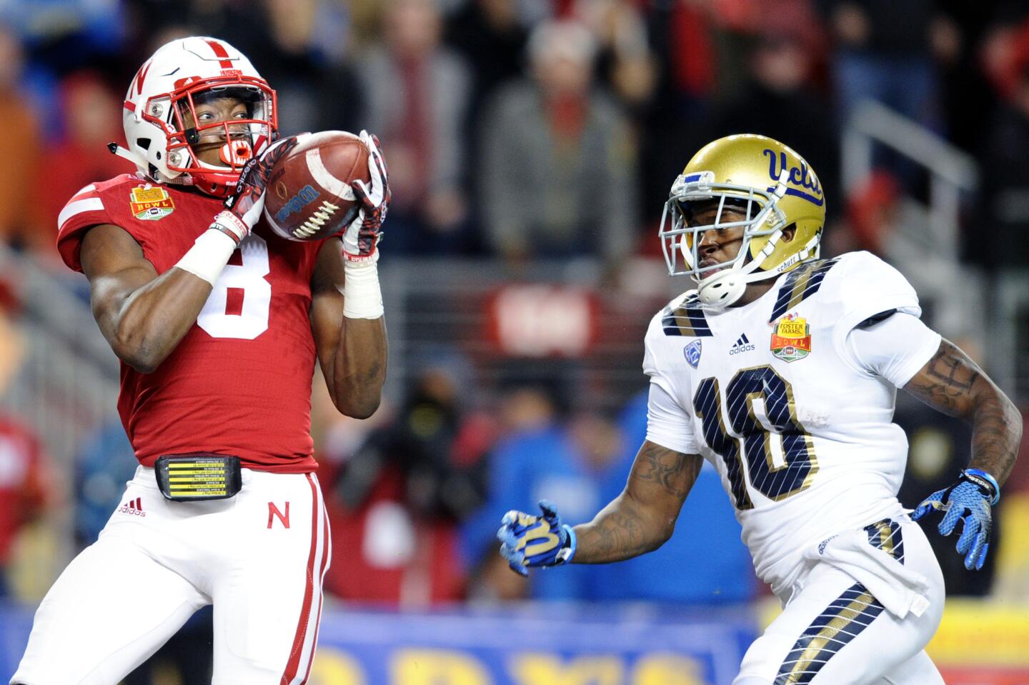 Nebraska defensive back Chris Jones intercepts a fourth-down pass intended for UCLA receiver Kenneth Walker III late in the fourth quarter of the Foster Farms Bowl on Saturday.