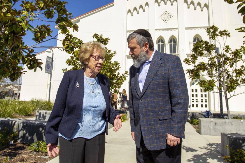 Eva Schloss, 89, a Holocaust survivor and Anne Frank's stepsister, speaks with Chabab Rabbi Reuven Mintz during a press conference at Newport Harbor High school on Thursday, March 7. Schloss met and talked with students invoived in a party made Nazi salutes around a Swastika that made of red cups during an off-campus party last week.