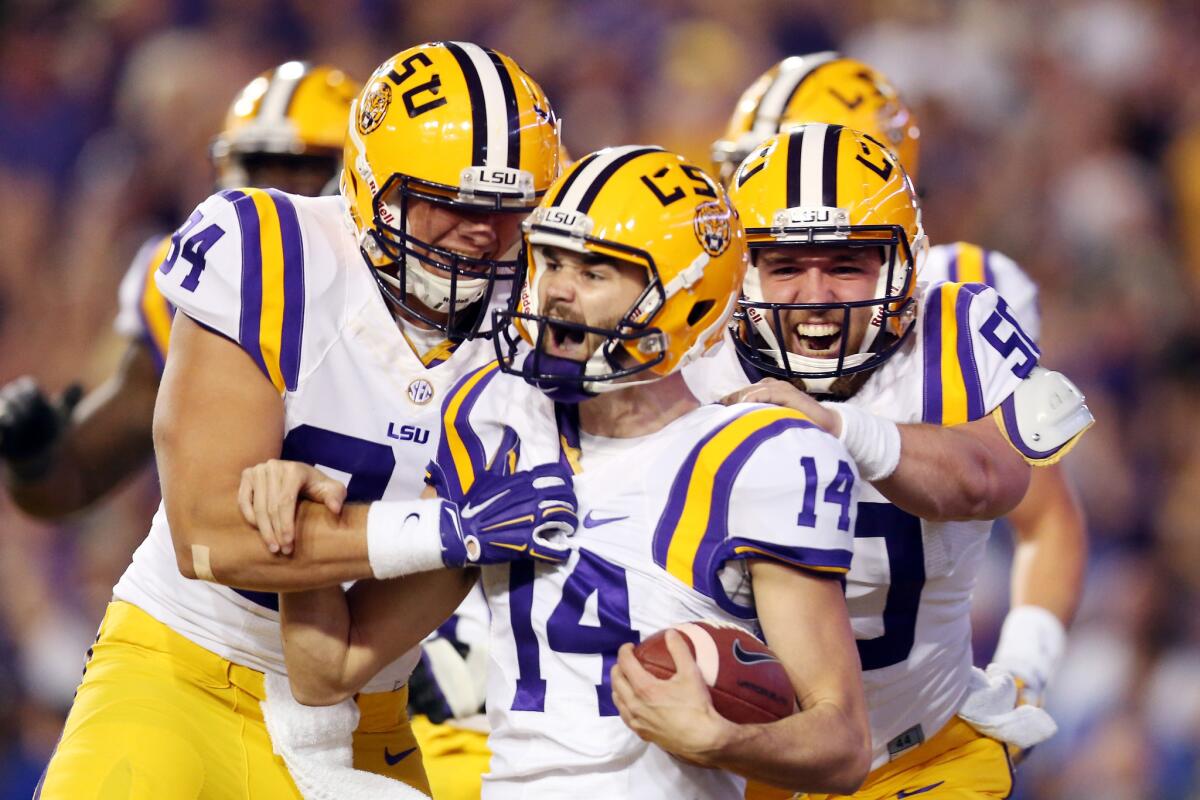 Louisiana State kicker Trent Domingue (14) celebrates after scoring a touchdown on a fake field goal against Florida in a 35-28 victory last season.