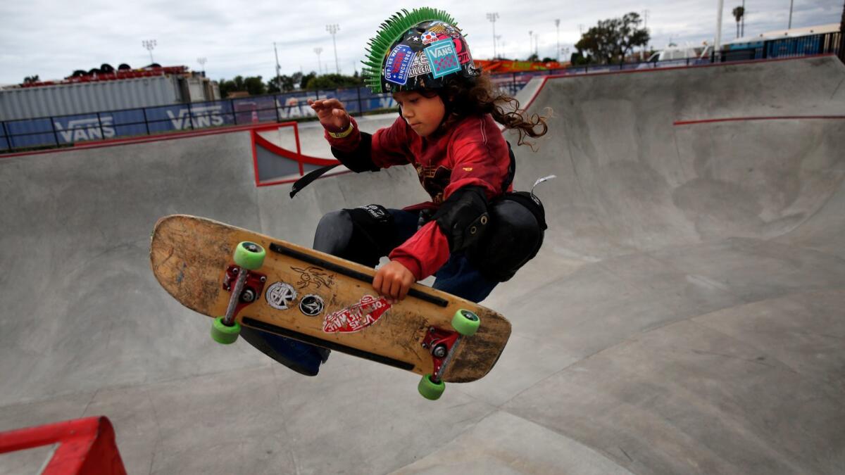 Julian Jeang-Agliardi jumps a ramp at Vans Off the Wall Skatepark.
