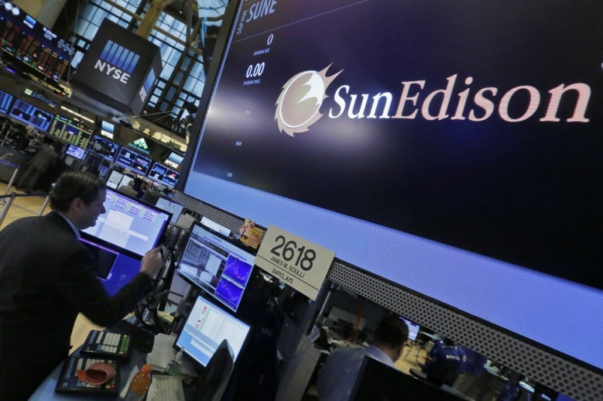 Specialist Gregg Maloney works at the SunEdison Inc. post on the floor of the New York Stock Exchange on March 8.