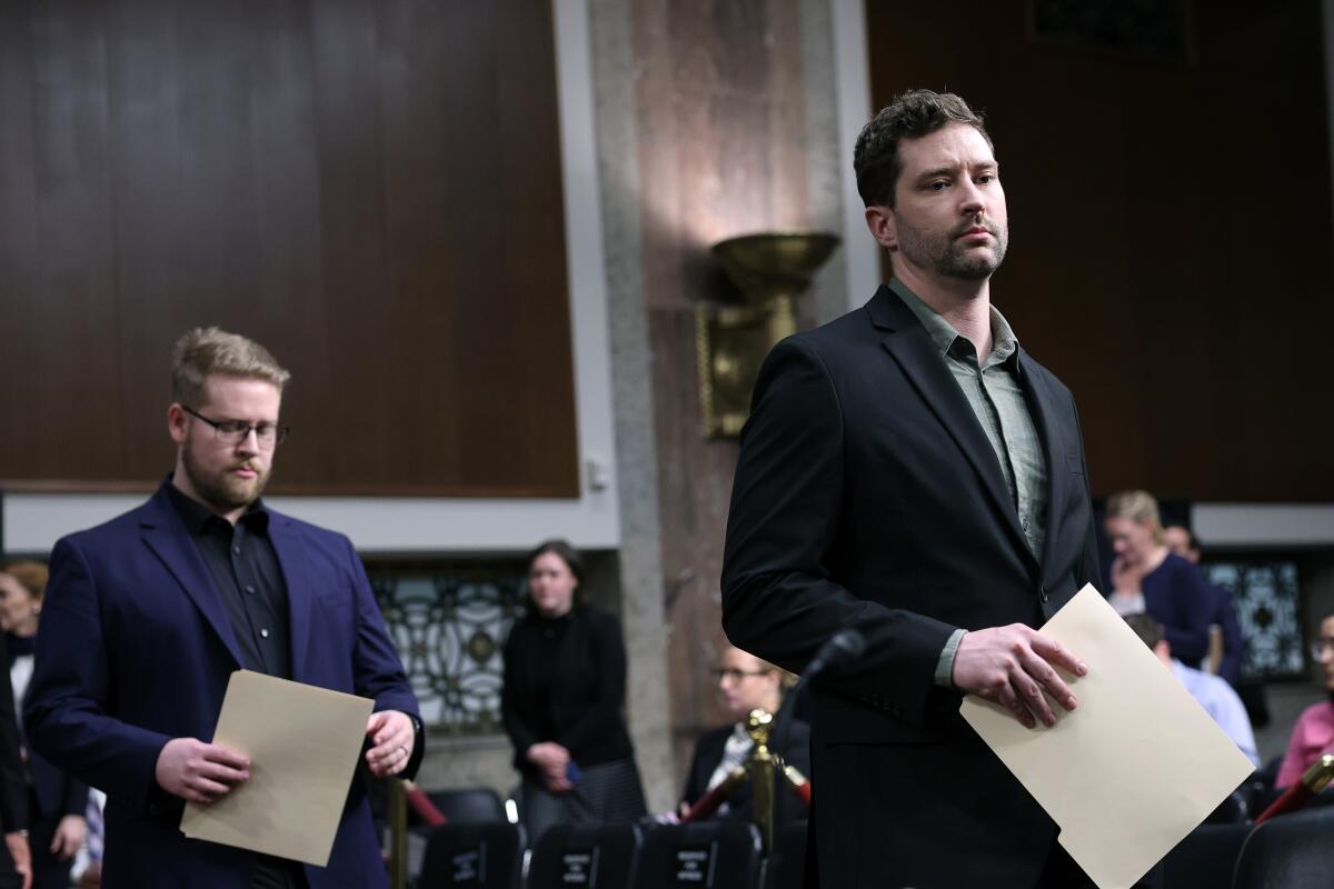 Luke Ganger and Brent Ganger arrive to a public forum