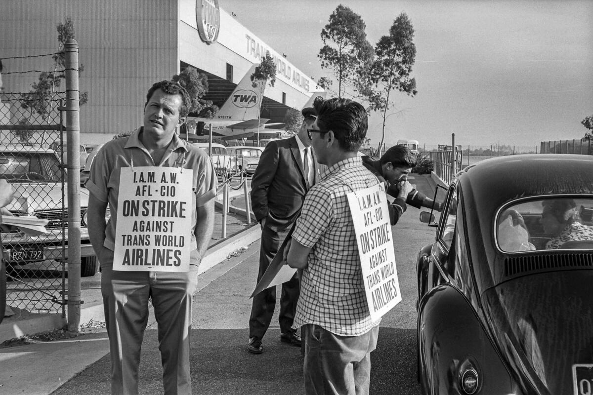July 8, 1966: Two members of the International Assn. of Machinists picket Trans World Airline hanger at Los Angeles International Airport. The strike against five airlines lasted 43 days.