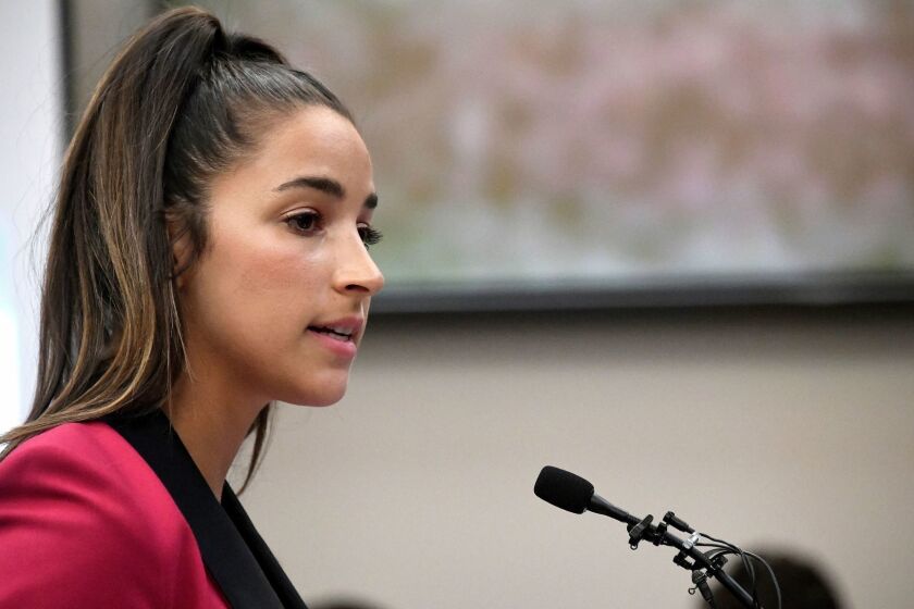 FILE- In this Jan. 19, 2018, file photo, Olympic gold medalist Aly Raisman gives her victim impact statement in Lansing, Mich., during the fourth day of sentencing for former sports doctor Larry Nassar, who pled guilty to multiple counts of sexual assault. Six-time Olympic medalist Aly Raisman is suing the U.S. Olympic Committee and USA Gymnastics, claiming both organizations "knew or should have known" about abusive patterns by a disgraced former national team doctor now in prison for sexually abusing young athletes.Raisman filed the lawsuit in California on Wednesday, Feb. 28, 2018. (Dale G. Young/Detroit News via AP, File)