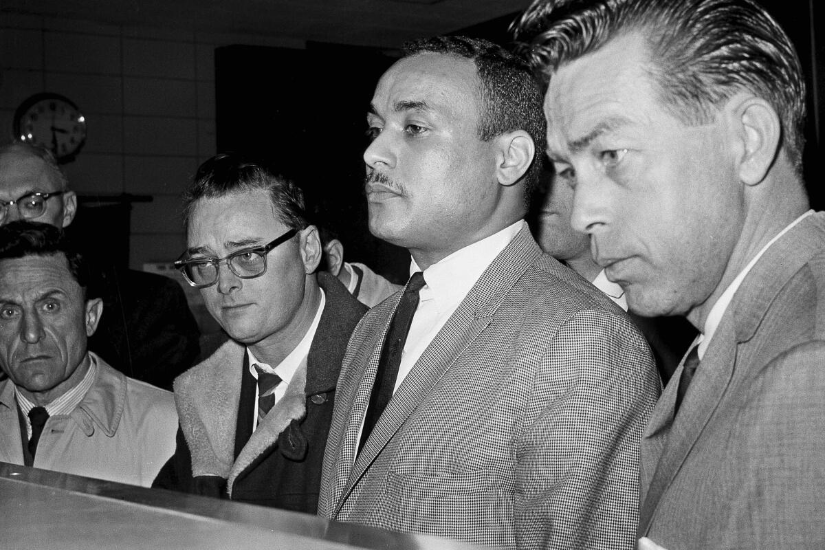 Thomas 15X Johnson is booked as the third suspect in the slaying of Malcolm X in 1965.