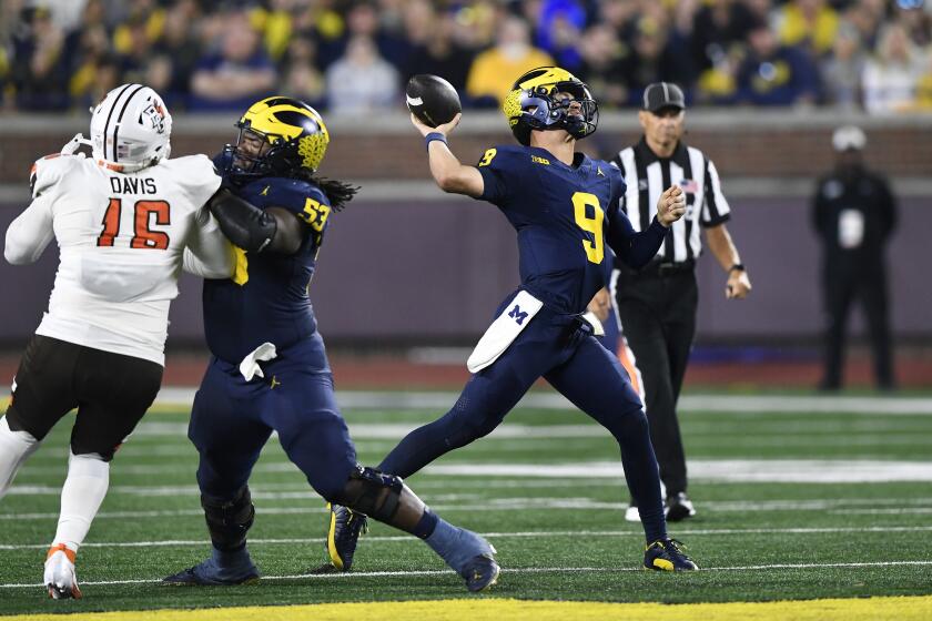 Michigan quarterback J.J. McCarthy (9) throws a touchdown pass to Cornelius Johnson during the second half of an NCAA college football game against Bowling Green, Saturday, Sept. 16, 2023, in Ann Arbor, Mich. (AP Photo/Jose Juarez)