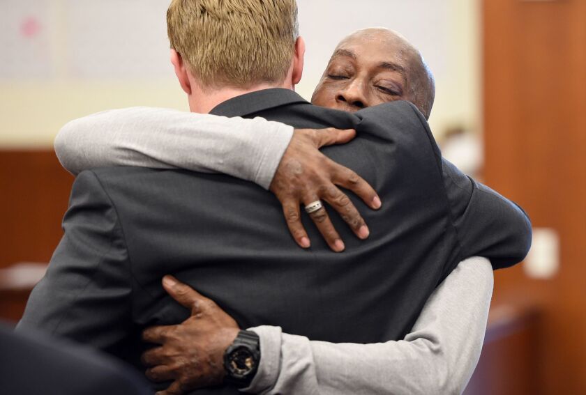DeWayne Johnson hugs one of his lawyers after hearing the verdict to his case against Monsanto at the Superior Court Of California.