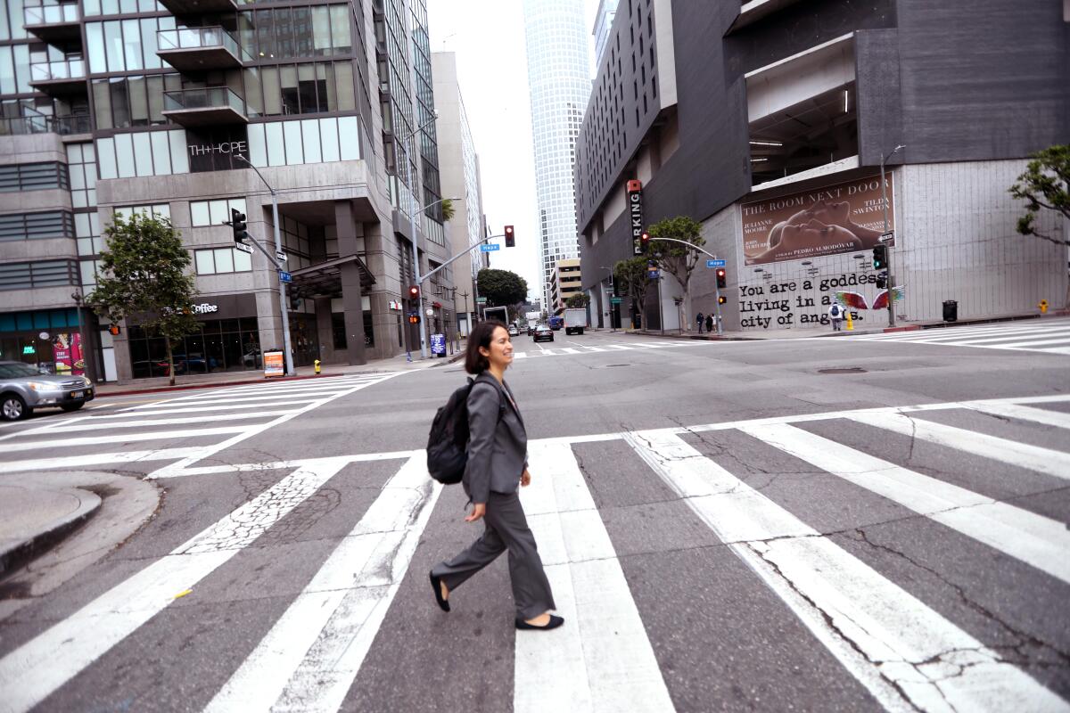 A woman walks to a bus stop