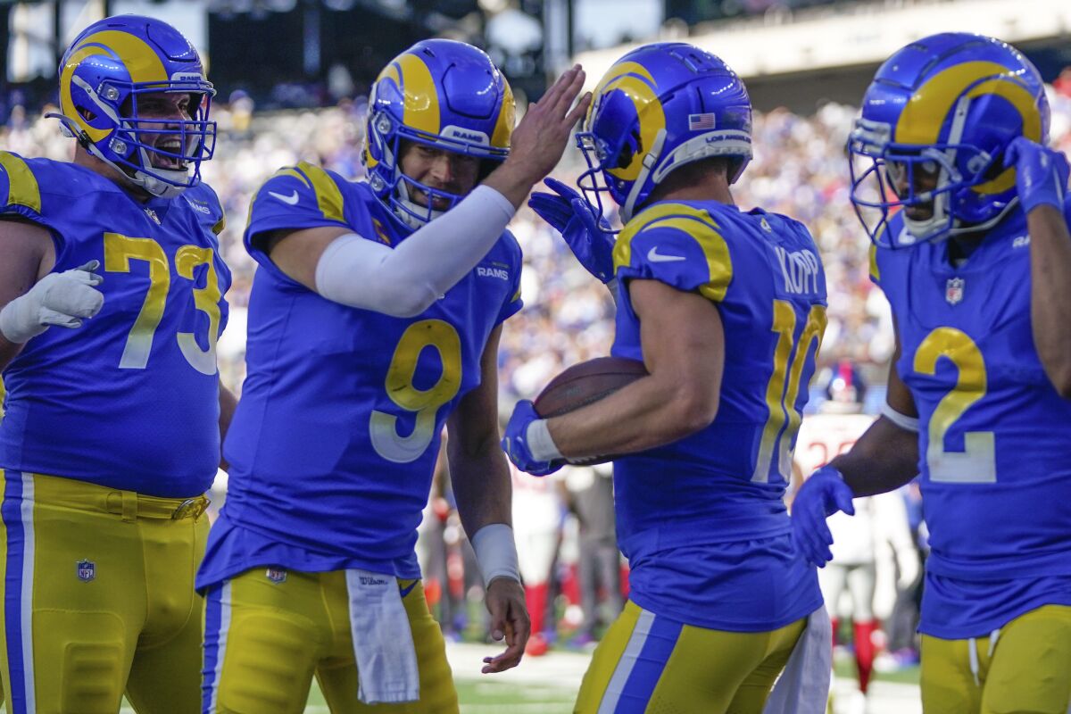 Los Angeles Rams' Cooper Kupp, second from right, celebrates his touchdown with quarterback Matthew Stafford (9), second from left, during the second half of an NFL football game against the New York Giants, Sunday, Oct. 17, 2021, in East Rutherford, N.J. (AP Photo/Frank Franklin II)