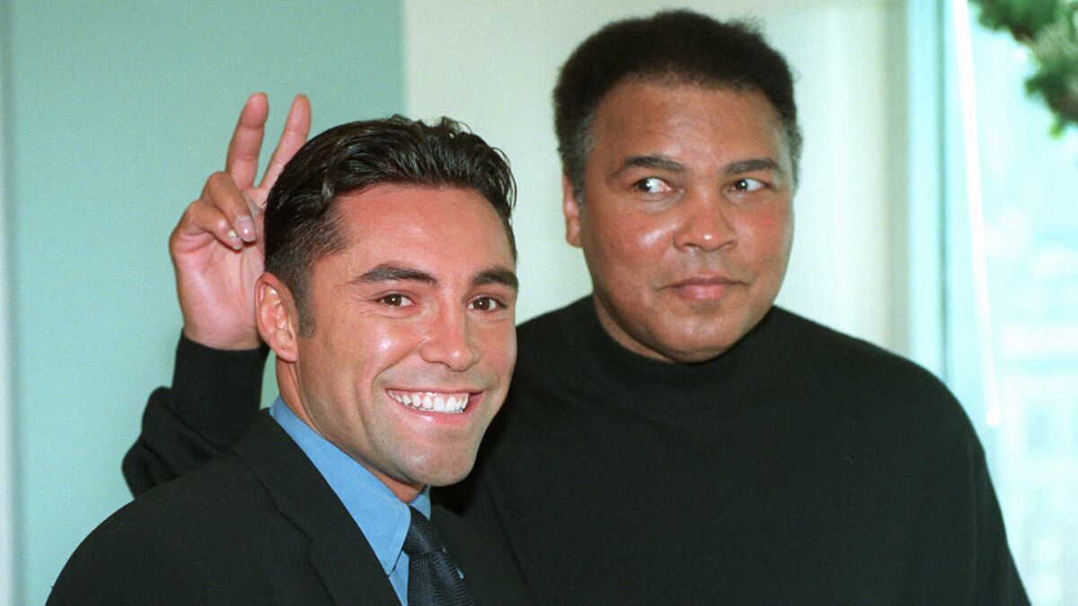 Boxing legend Muhammad Ali, right, clowns around with Oscar De La Hoya while appearing together in New York on Dec. 2, 1997.