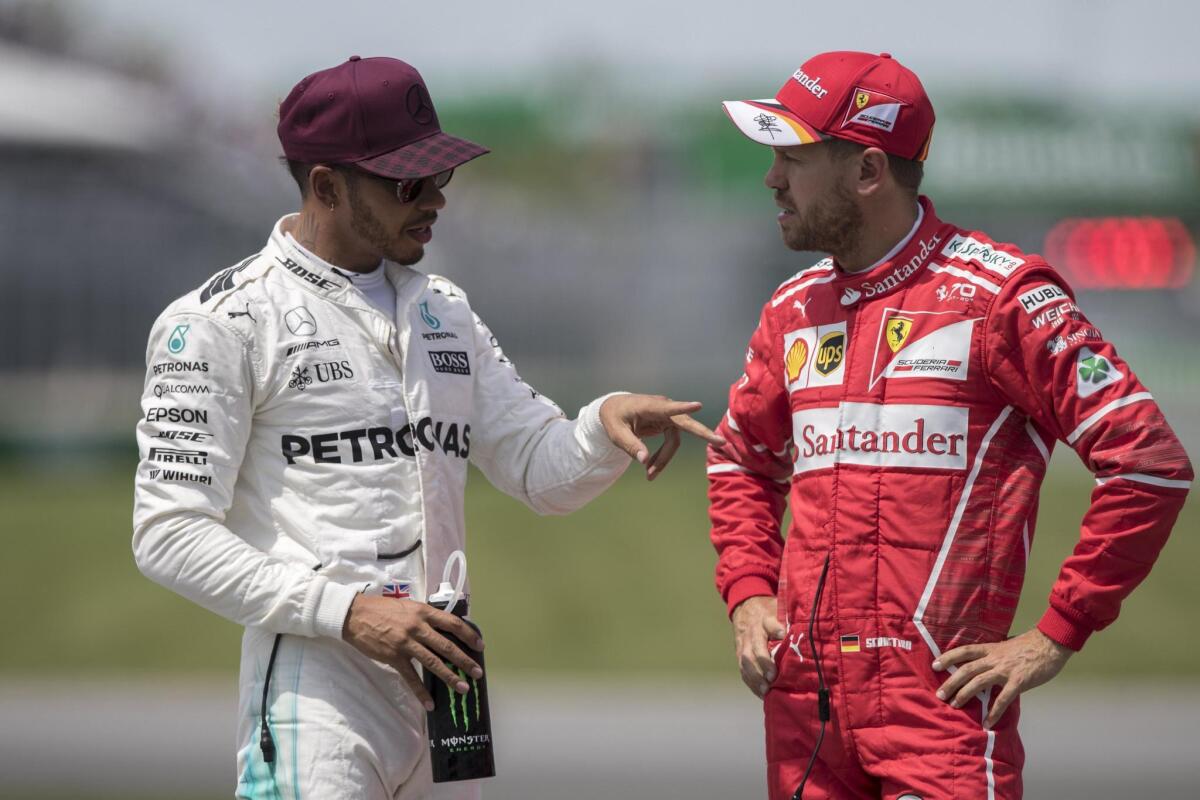 Lewis Hamilton (izq.) y Sebastian Vettel.