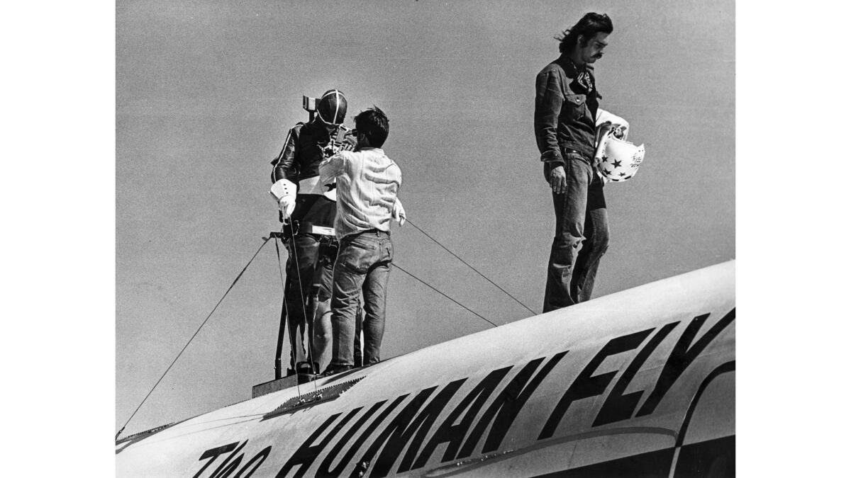 June 19, 1976: The daredevil is strapped into a brace atop the plane.
