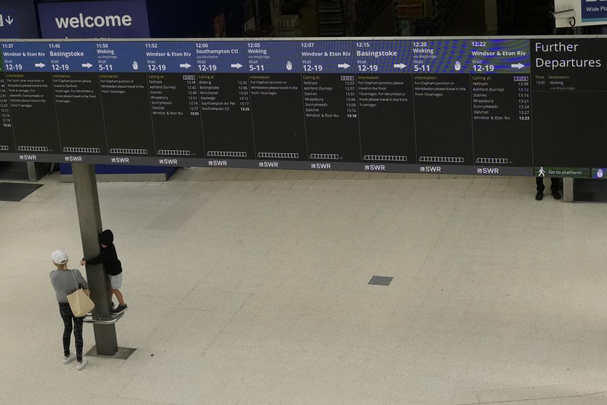 Train departure screens show which services are running, inside a much quieter than normal Waterloo railway station, in London, during a strike held by railway workers, Saturday, June 25, 2022. Train stations are all but deserted across Britain on the third day of a national strike that snarled the weekend plans of millions. Train companies said only a fifth of passenger services would run on Saturday. (AP Photo/Matt Dunham)