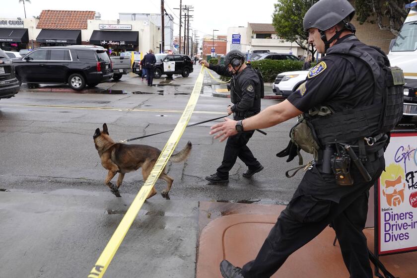 San Diego SWAT members walk along Robinson Ave. in Hillcrest as they respond to a possible suicidal man who fired a gun at police officers from a building on March 12, 2020. The shootings occurred on Fourth Avenue near Robinson Avenue about 1 p.m., about three hours after police first responded to a report of a suicidal man, police Officer Billy Hernandez said. The caller told police the man was armed with a shotgun.